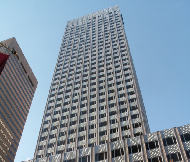 Photo looking upwards at midcentury office tower with thick aluminum cladding