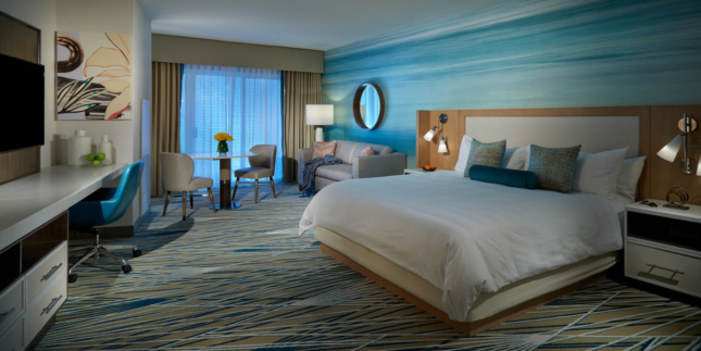Interior photo of a hotel room with a blue tint