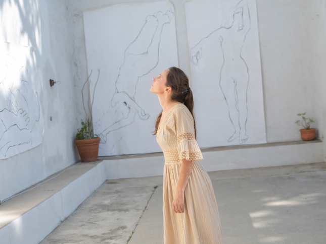 woman in front of white walls and artwork