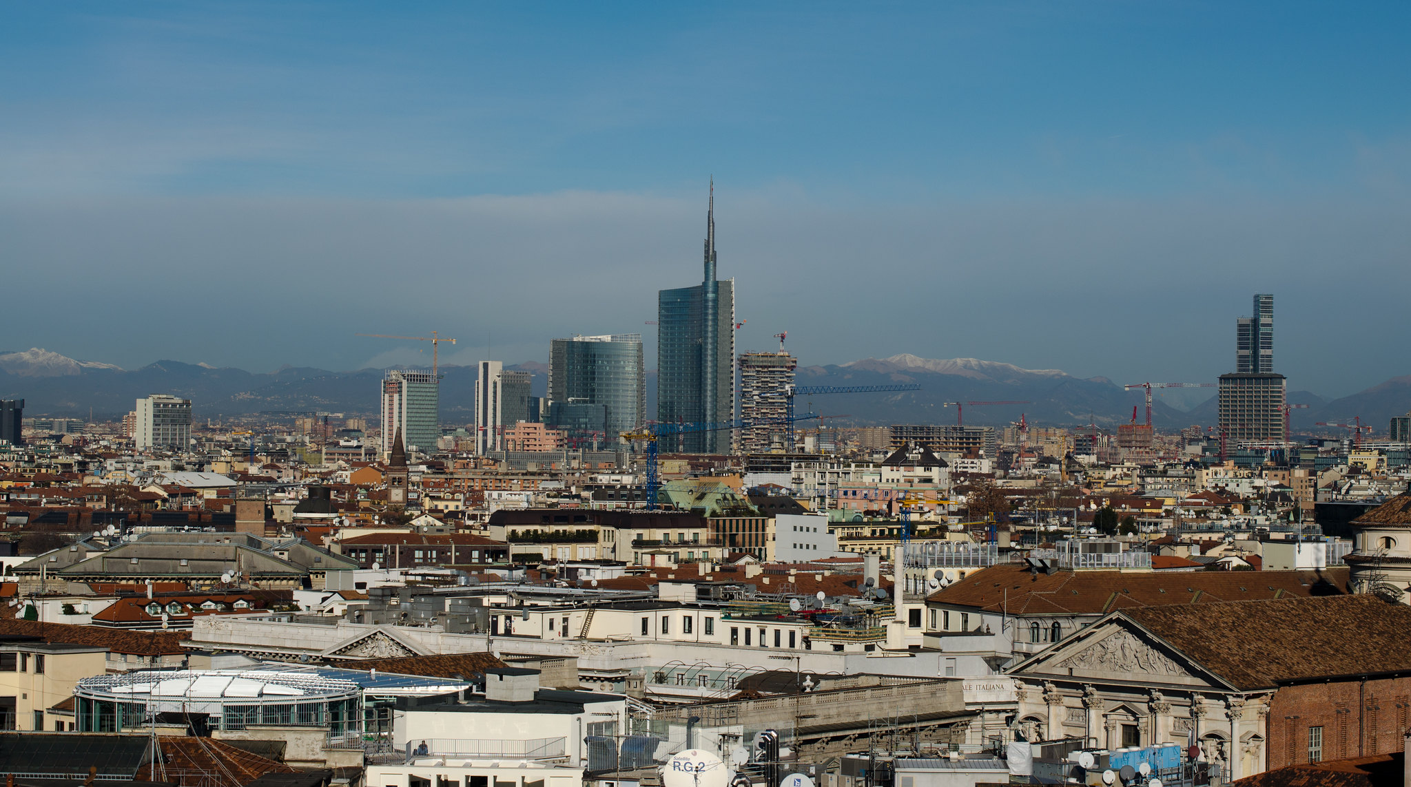 The skyline of Milan, Italy, showing flat historical buildings against towers