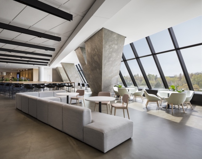 Dining area and lounge at Montreal's converted Olympic Tower, showing large exposed concrete structural elements