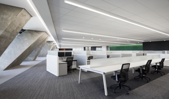 workspace inside Montreal's renovated Olympic Tower, showing white desks on a full floor