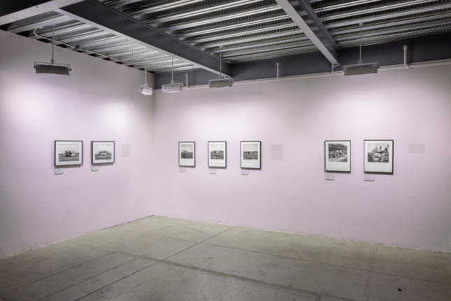 pink walls with framed photographs