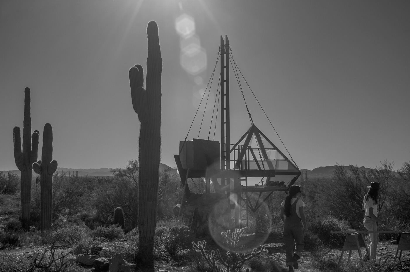 A photo of students erecting a tent in the desert of Taliesin
