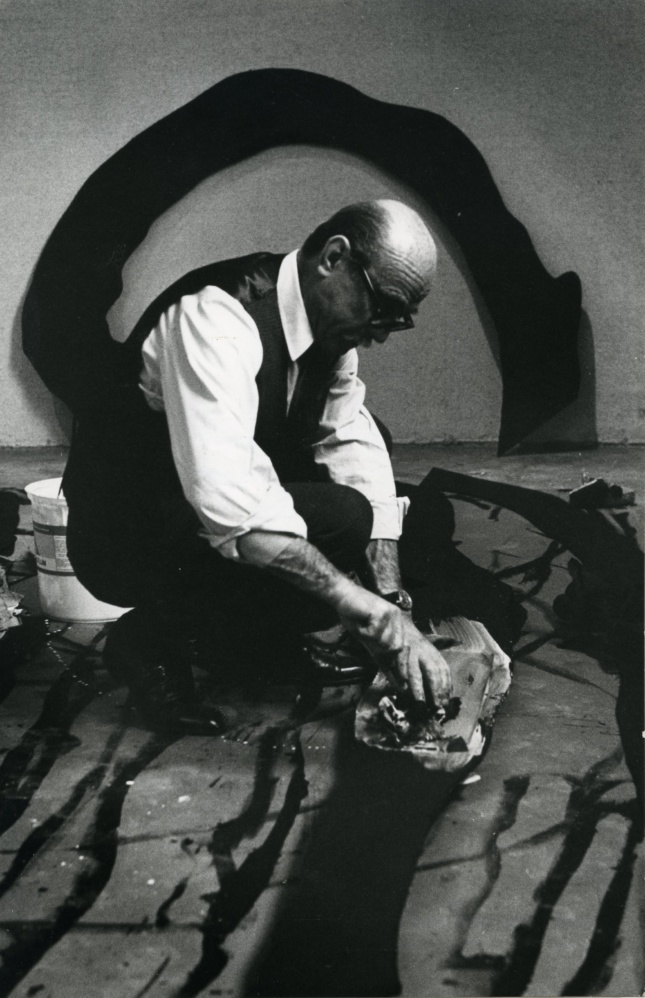 man on floor painting, Lucio Fontana
