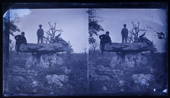 two identical purple photos of people on a rock structure