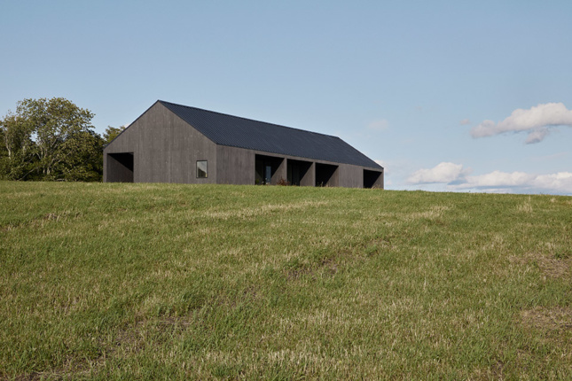 A long, barn-like house in a field