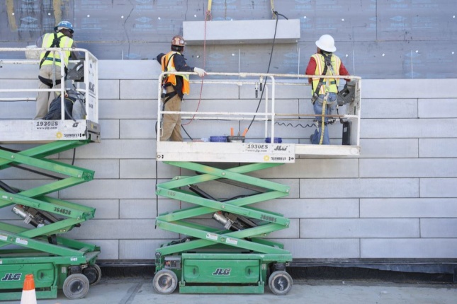 Construction image of concrete installation of The Glenstone Museum, with men on a scissorlift