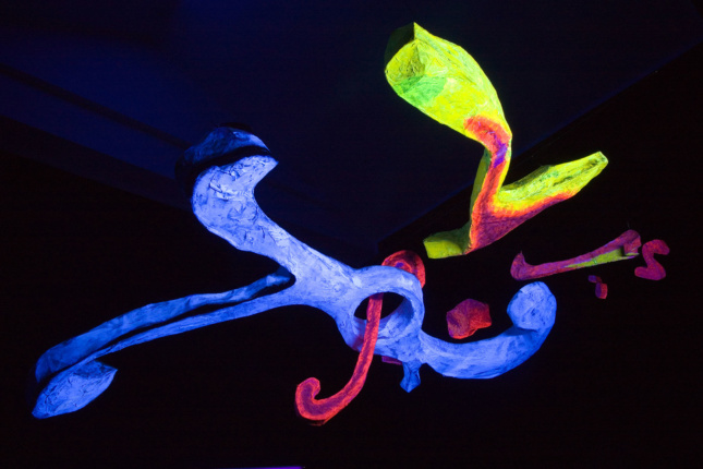 multi-colored sculpture in dark space