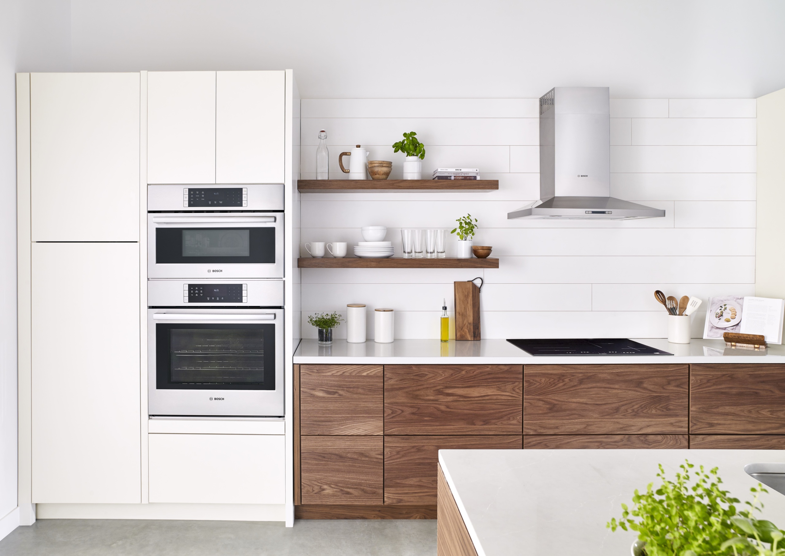 Interior of a kitchen with new appliances and wood shelve