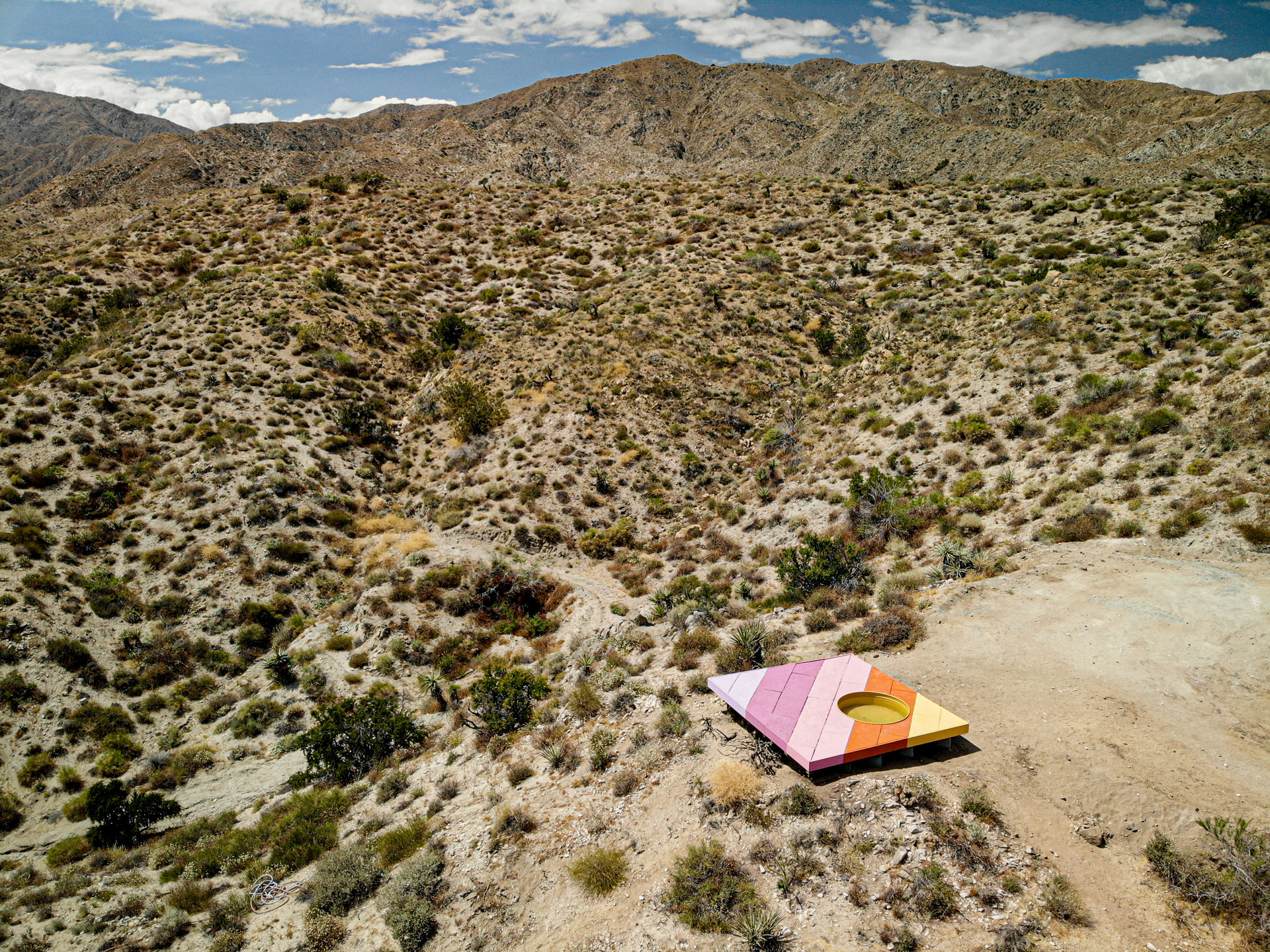 A vast valley with a desert, and a colorful board installation