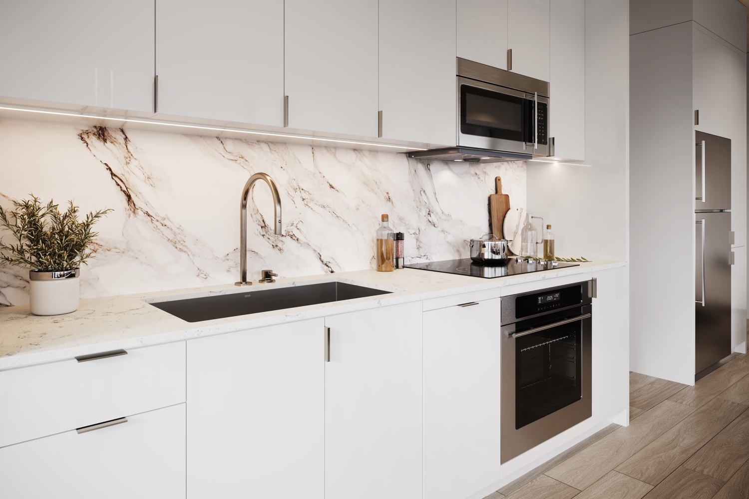 Interior of a kitchen with marble blacksplash and white cabinets