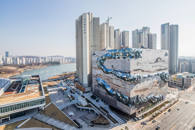 A bizarre-looking building set against a cluster of high-rises in South Korea.