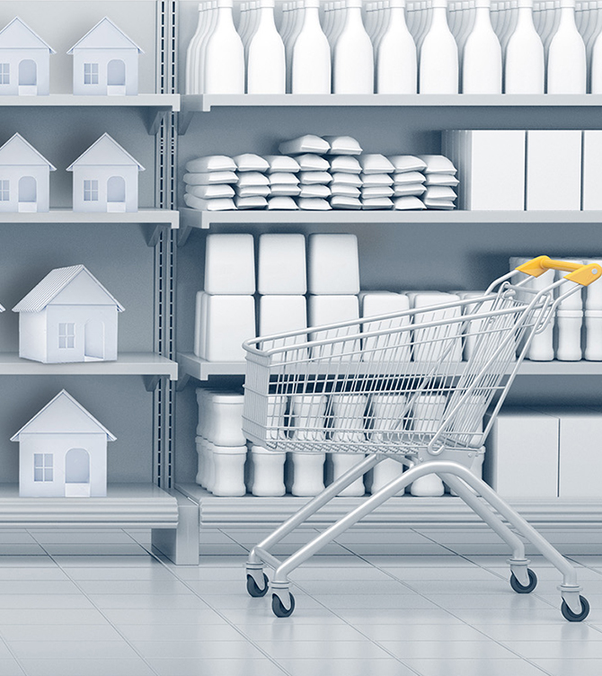 shopping cart in an all grey grocery aisle, products on shelves are houses