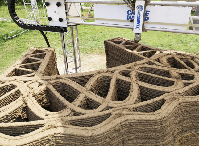 A nozzle 3D printing layers of dirt
