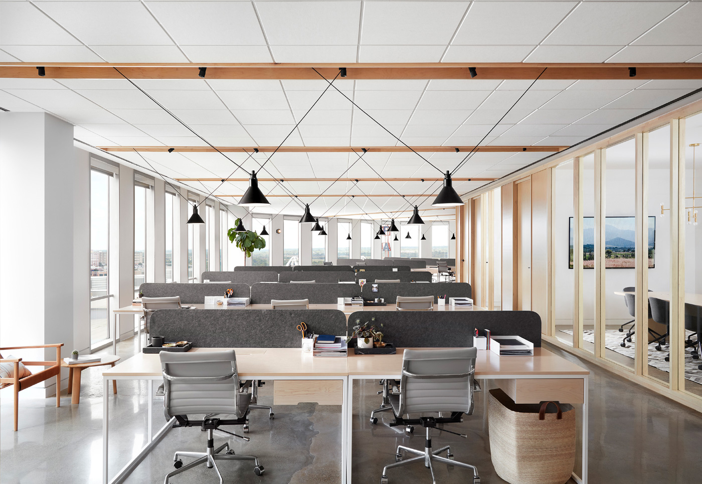 The Thoughtbarn-designed office has pendant lights and exposed beams
