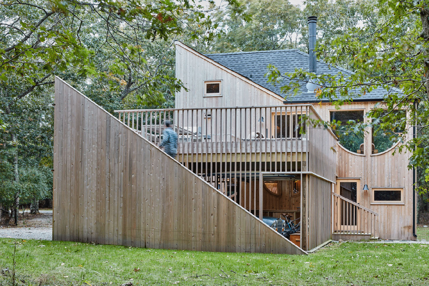 Wooden building with surrounding landscape designed by Andrew Geller
