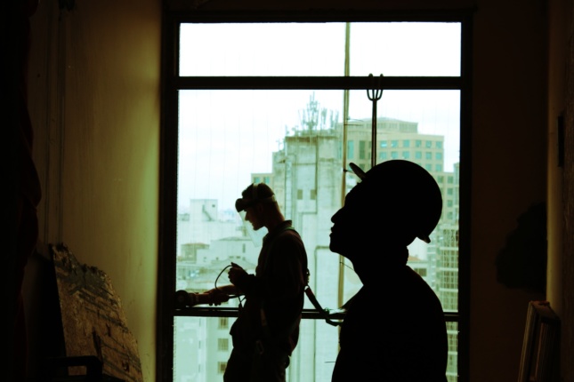 Photo of construction workers in silhouette