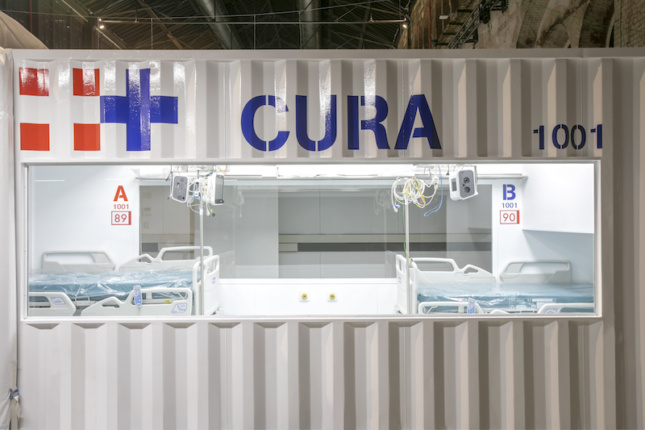 a container-based intensive care pod in italy, with a sign that says CURA
