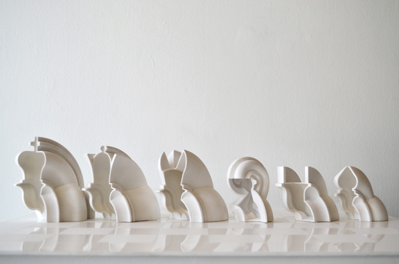 White, highly-designed chess set with curved pieces designed by Spinagu