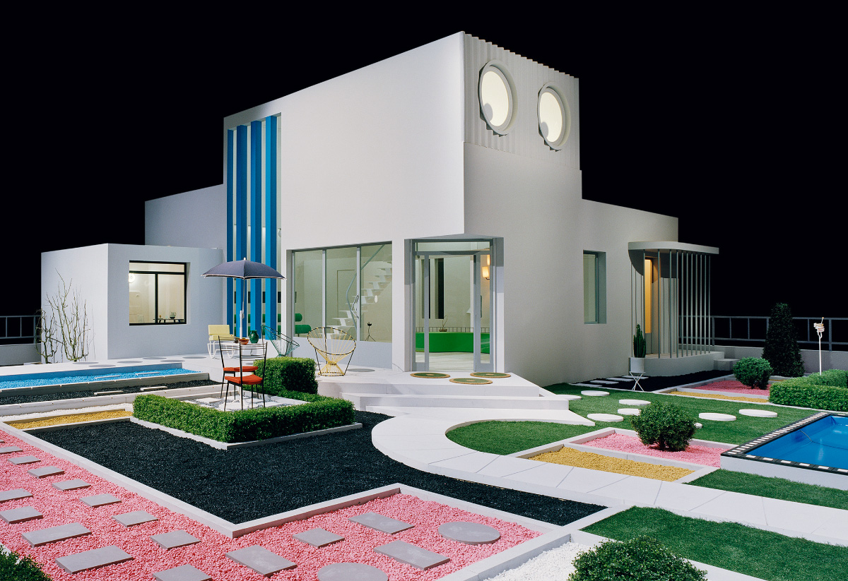 Exterior of a modernist house with colorful courtyard, from a Jacques Tati movie