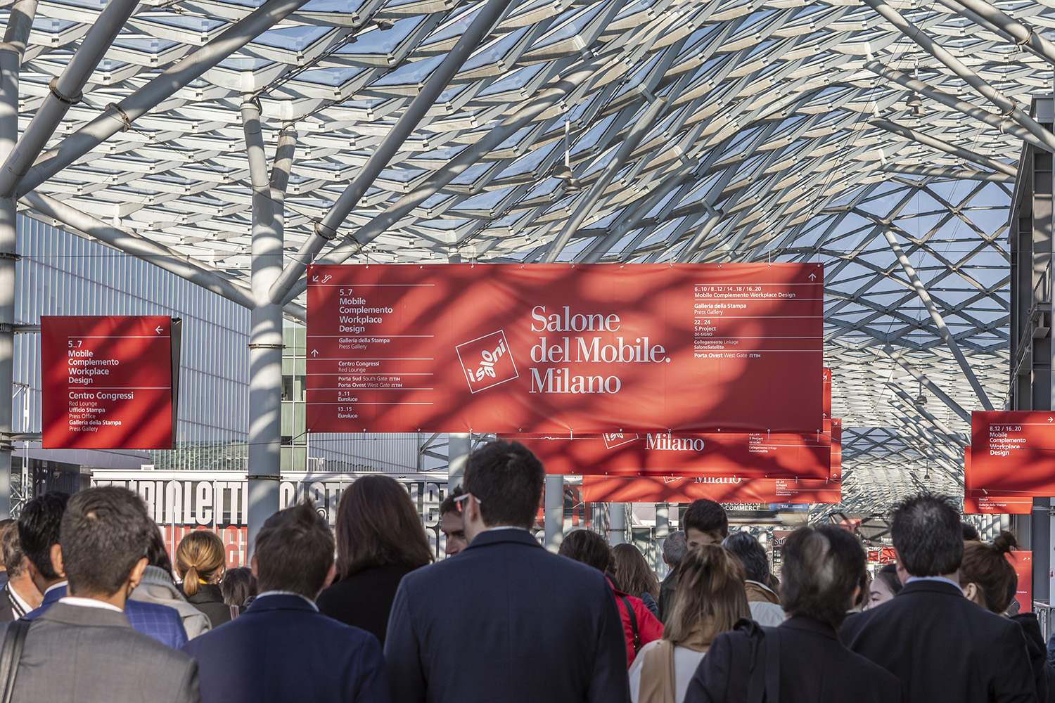 Interior photo of a festival with a red Salone del Mobile banner