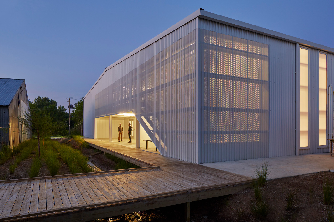 A warehouse clad in perforated aluminum, for the University of Arkansas