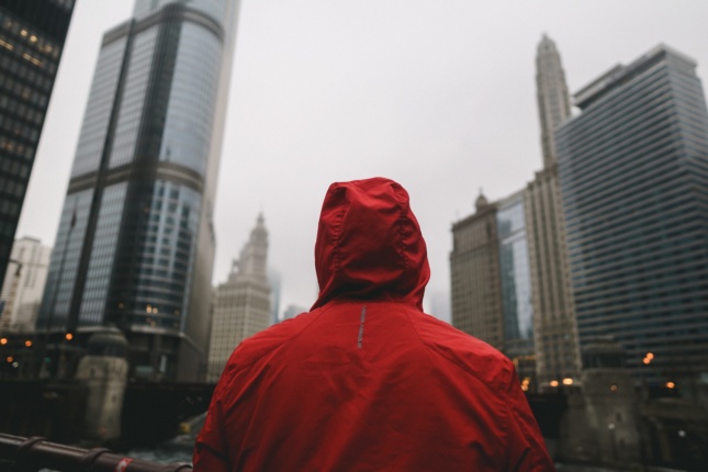 Photo of a person in a hood in downtown Chicago