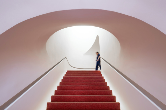Interior photo of a white staircase in a makeup store