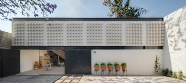 A low-slung white brick building designed by Architectural League Prize winner Vrtical