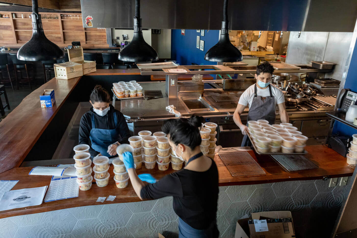 Employees at a restaurant preparing meals for pandemic frontline workers