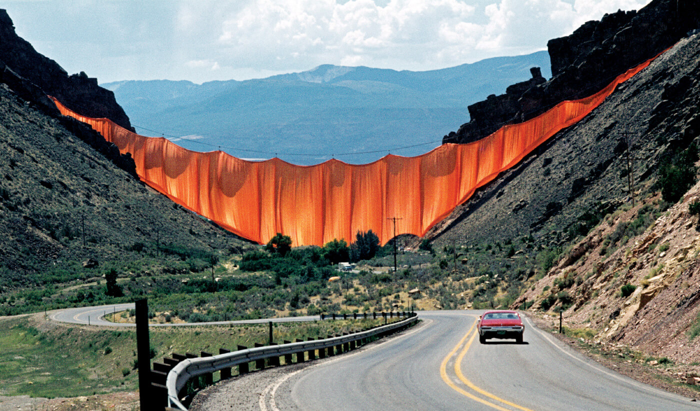 The christo-suspended wall of fabric spanning a valley