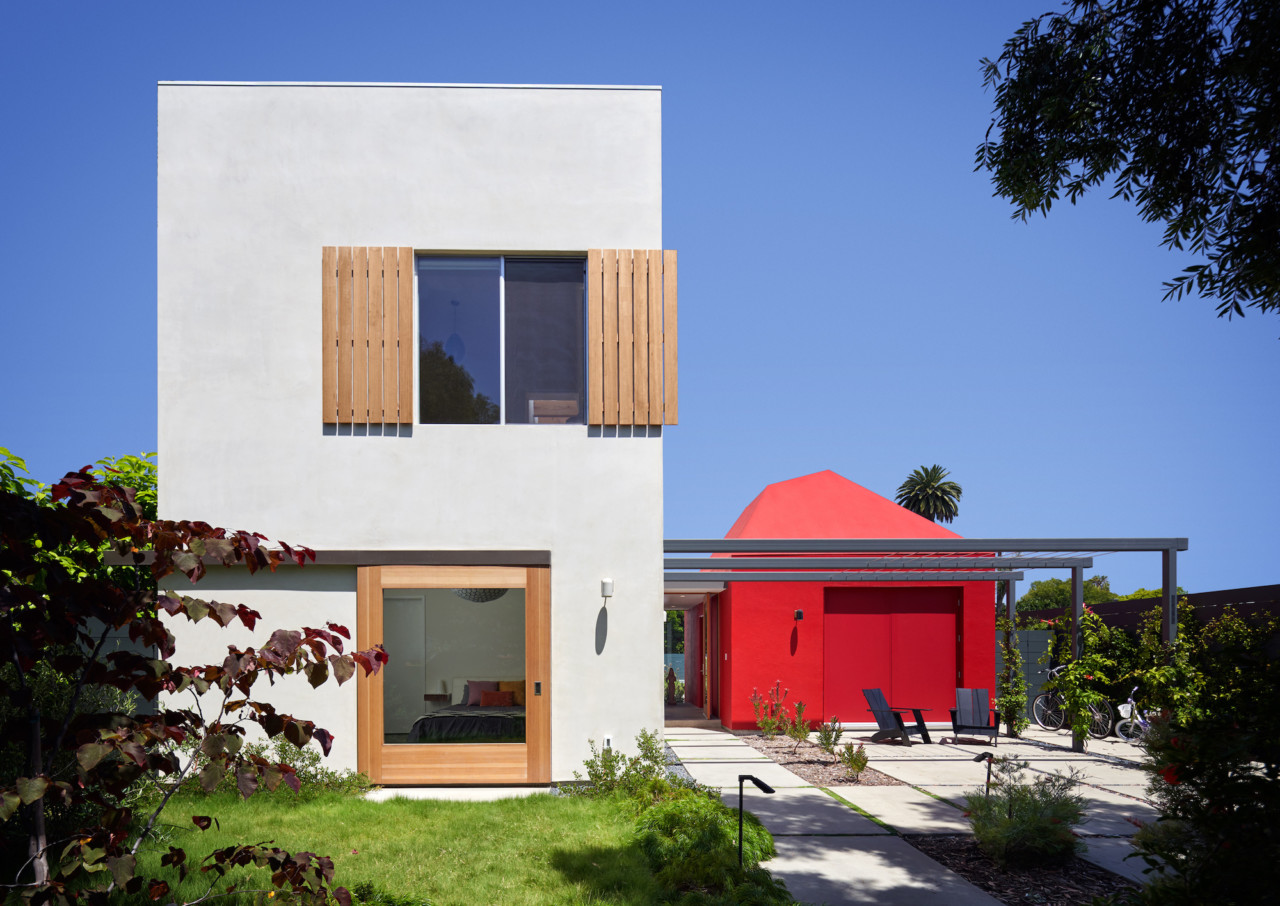 Boomerang house, a white blocky structure with a red addition