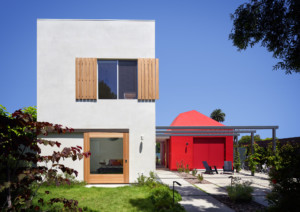 Boomerang house, a white blocky structure with a red addition