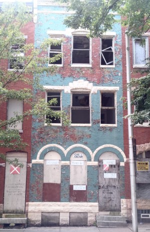 cab calloway house in baltimore, a decrepit red and blue row home