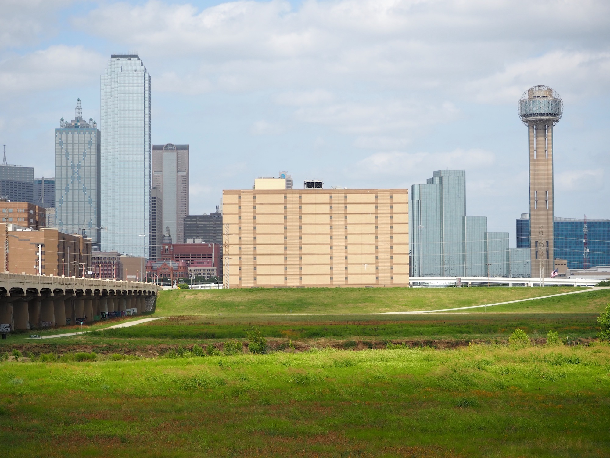 a jail building and the dallas skyline, which will be revamped by WEISS/MANFREDI