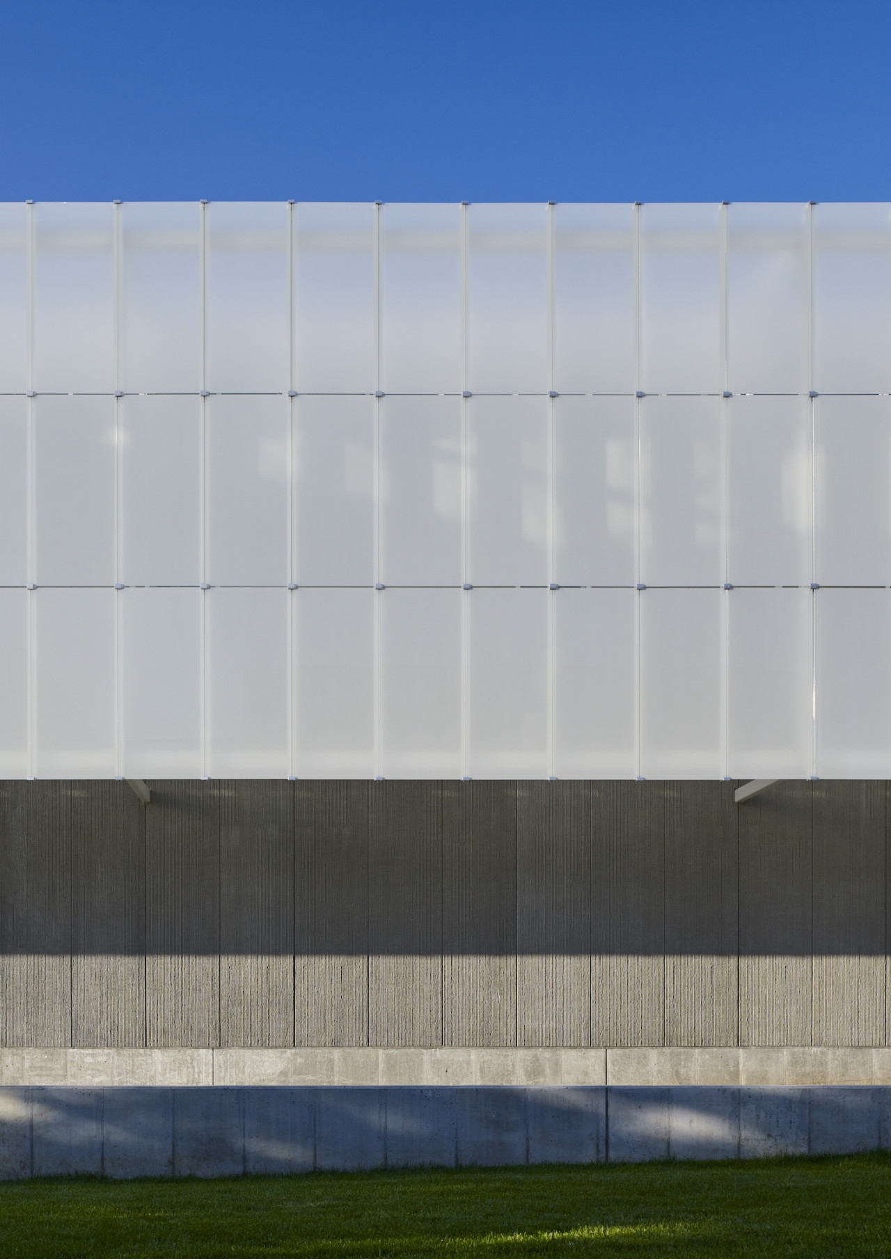 Image of the facade offset from the structure showing a grey screen on the Fine Arts + Design Studios