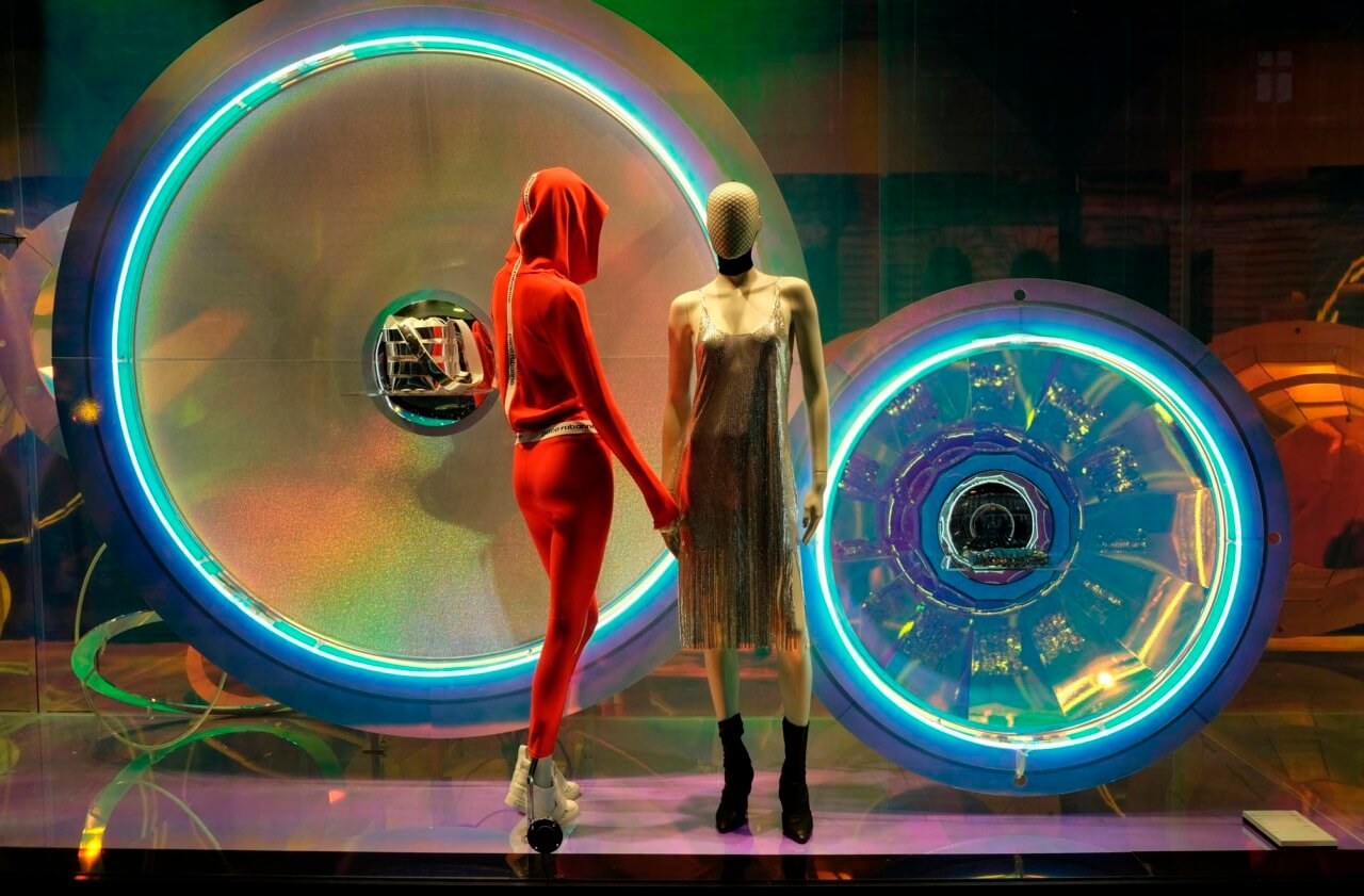 Photo of mannequins in a multicolored storefront window