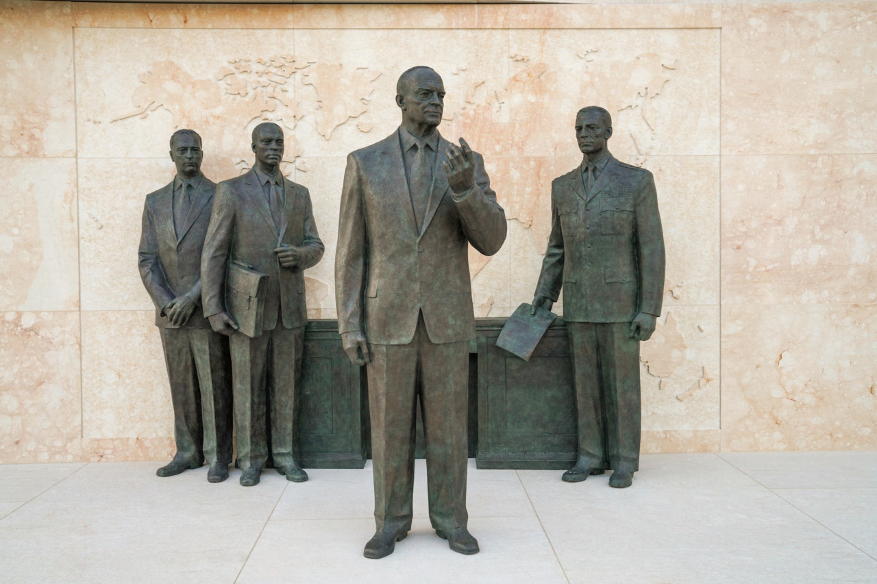 four statues of men standing around