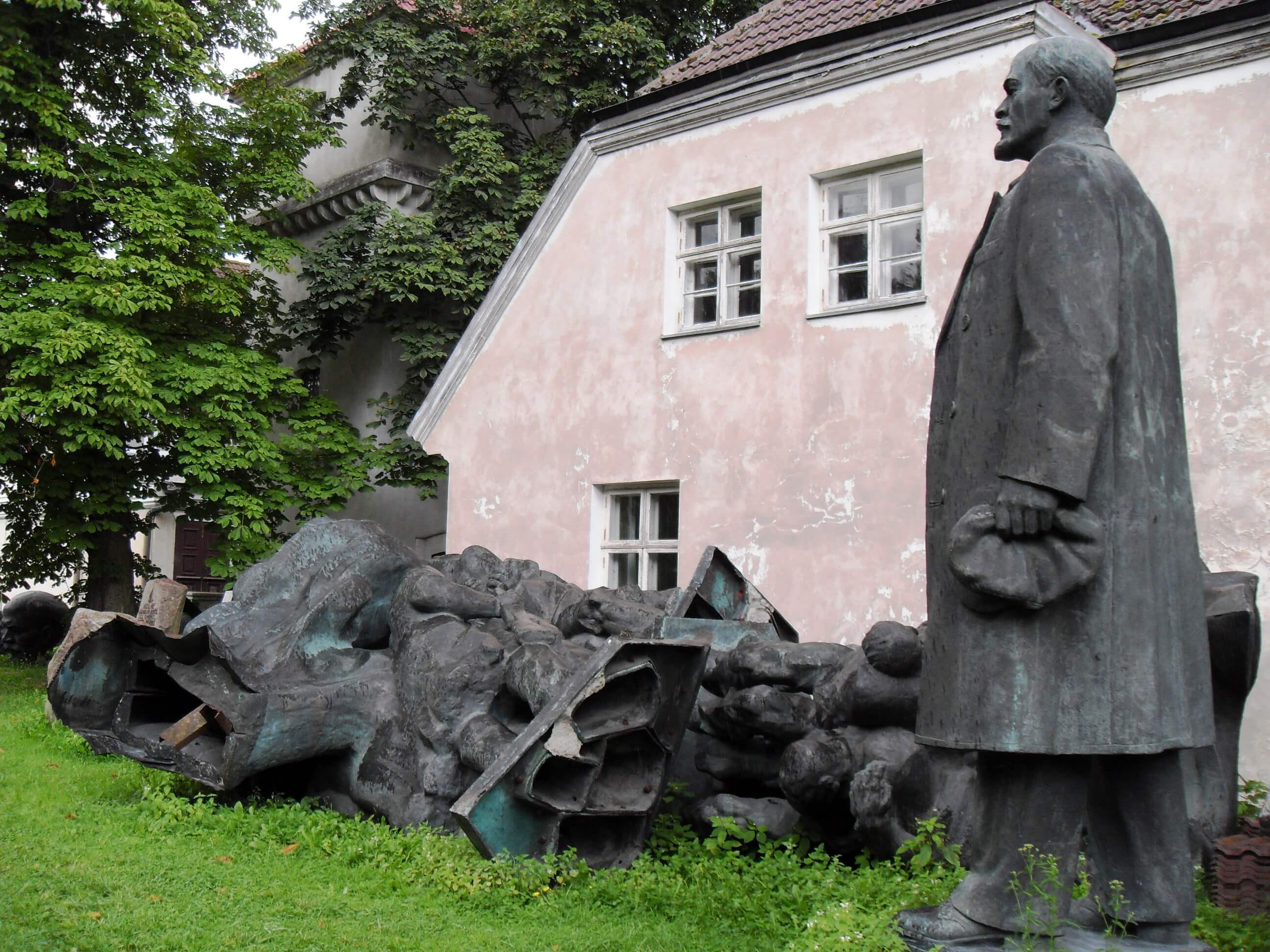 A statue of lenin amid toppled monuments