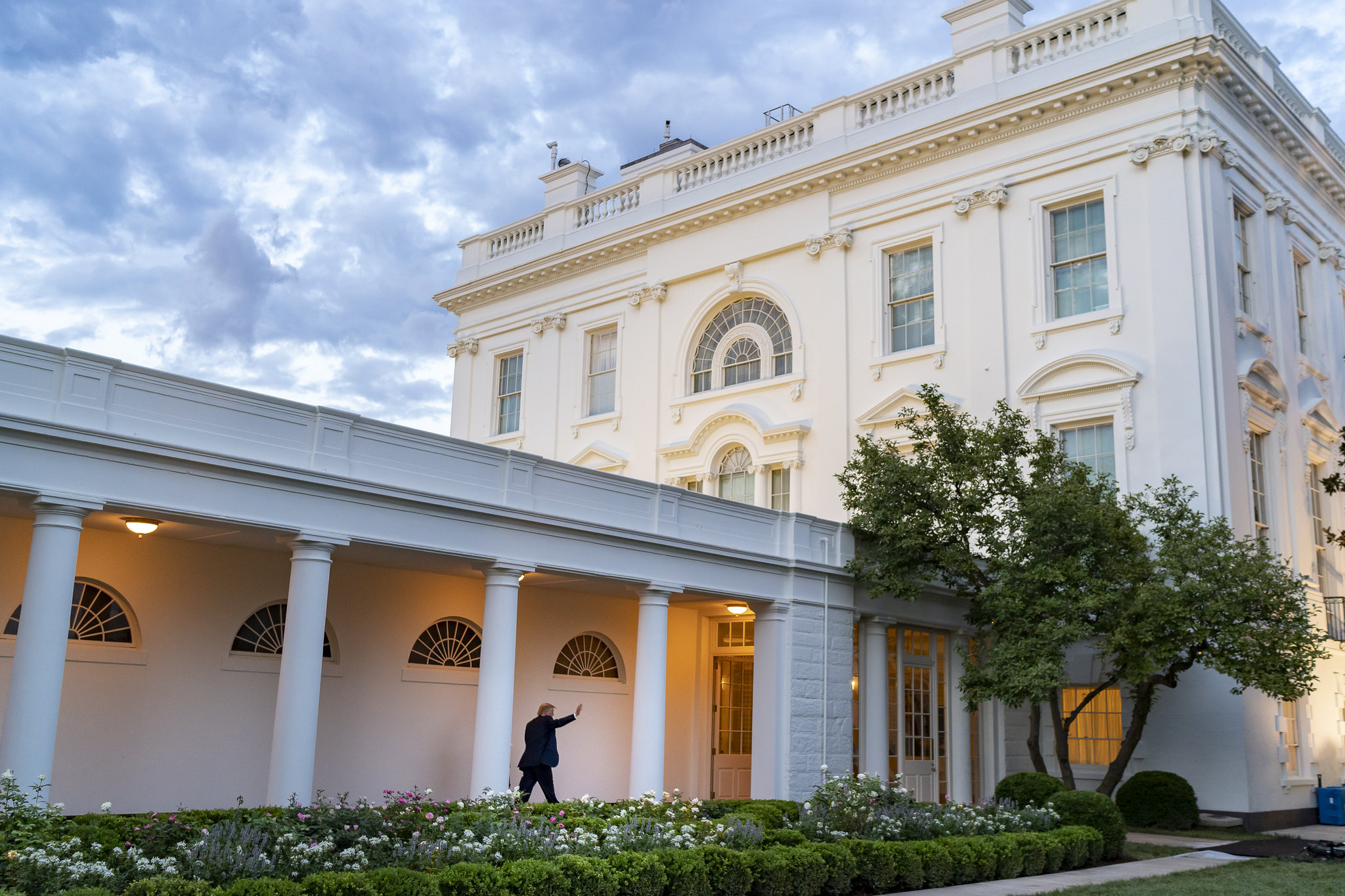 a person walking along the colonnade at the white house