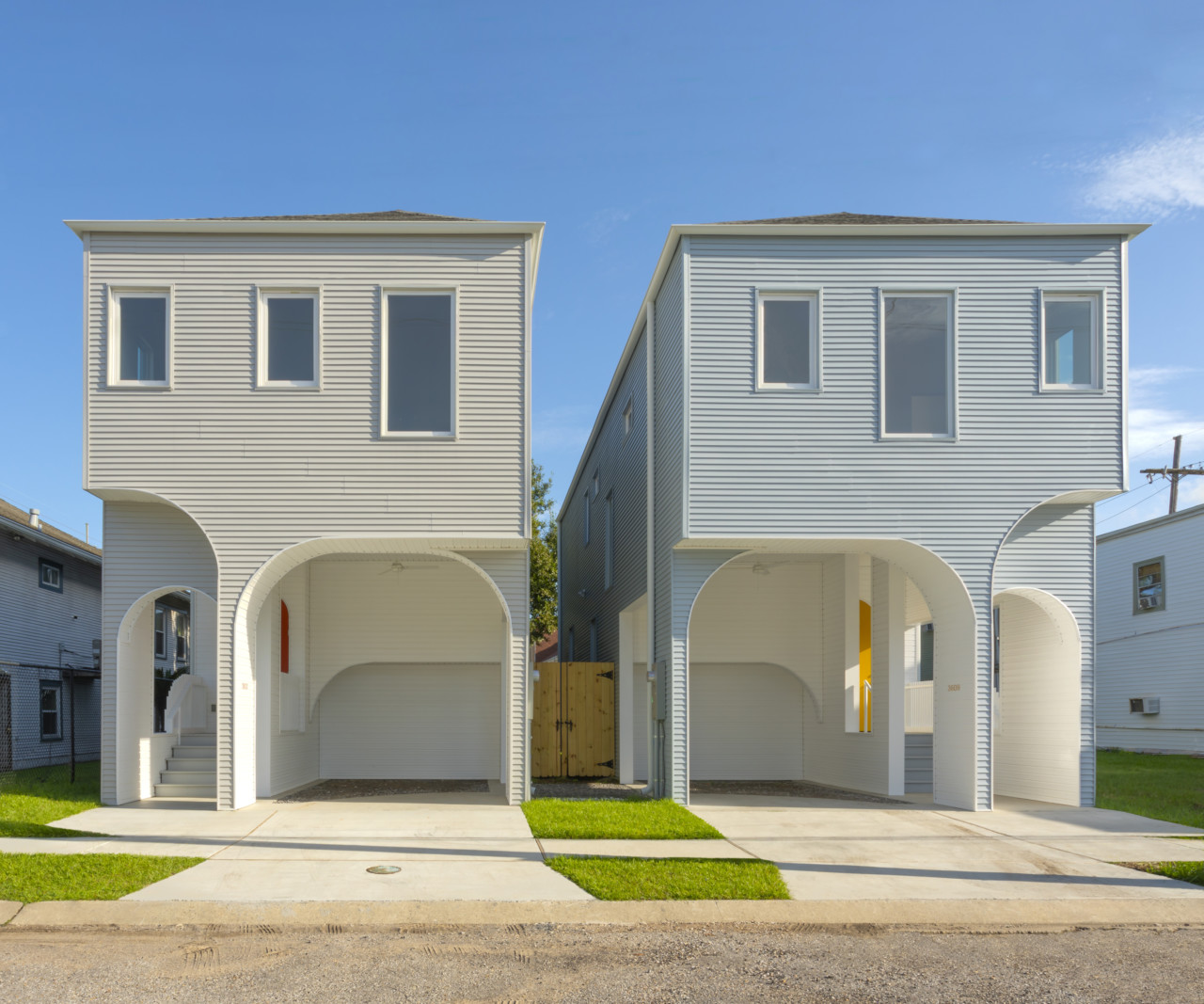 Two homes with colonnades out front, designed by office of jonathan tate