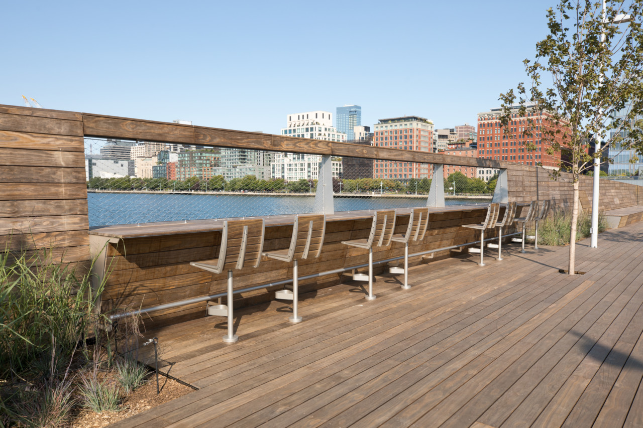 A wooden walkway with benches on pier 26