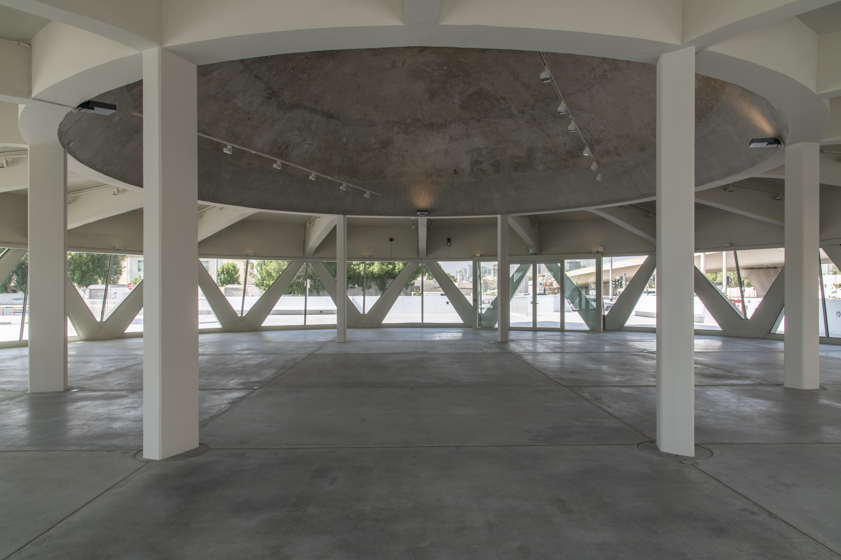 Interior of a concrete gallery supported by eight columns