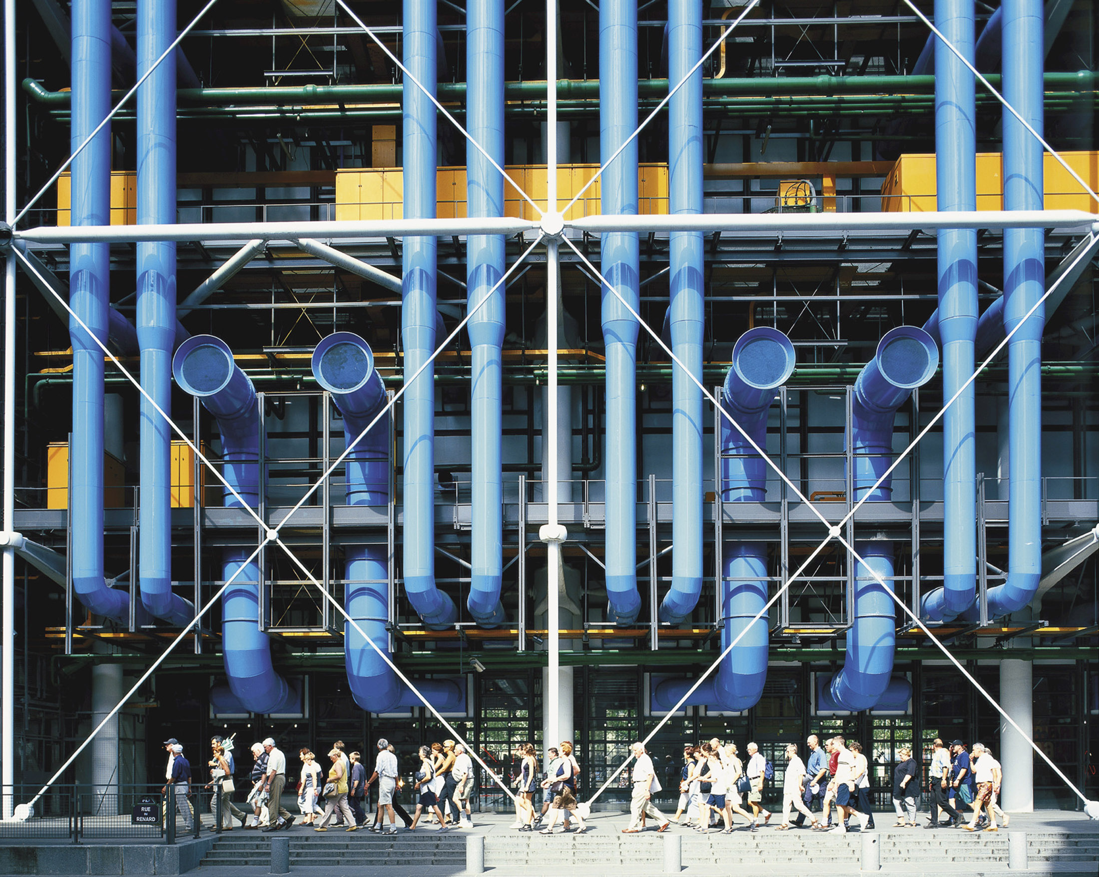 a facade of a contemporary art museum with large blue pipes, designed by Richard Rogers