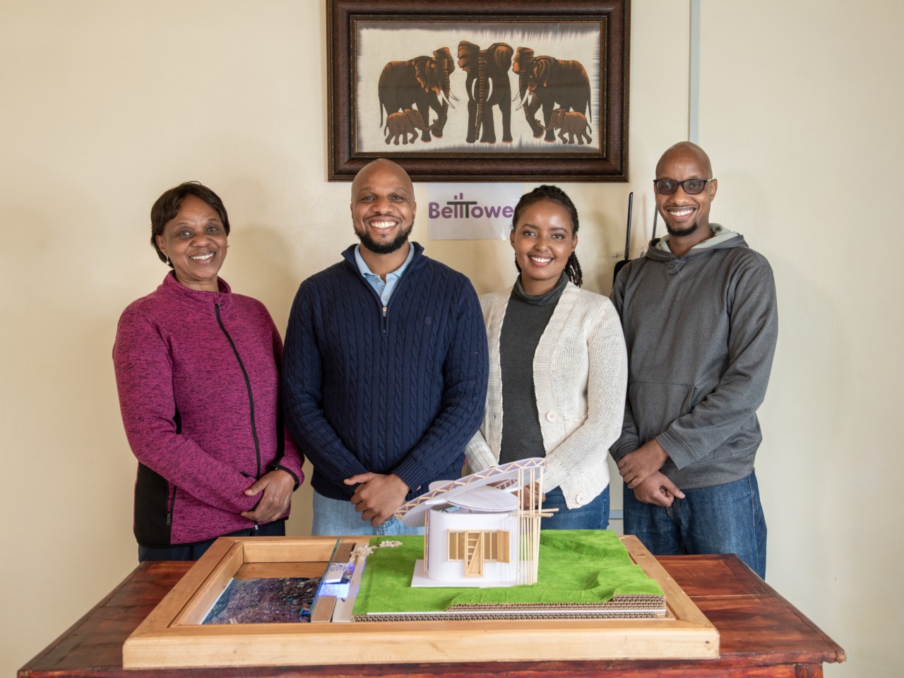 Photo of four people standing behind an architectural model for the Lexus Design Award 2020