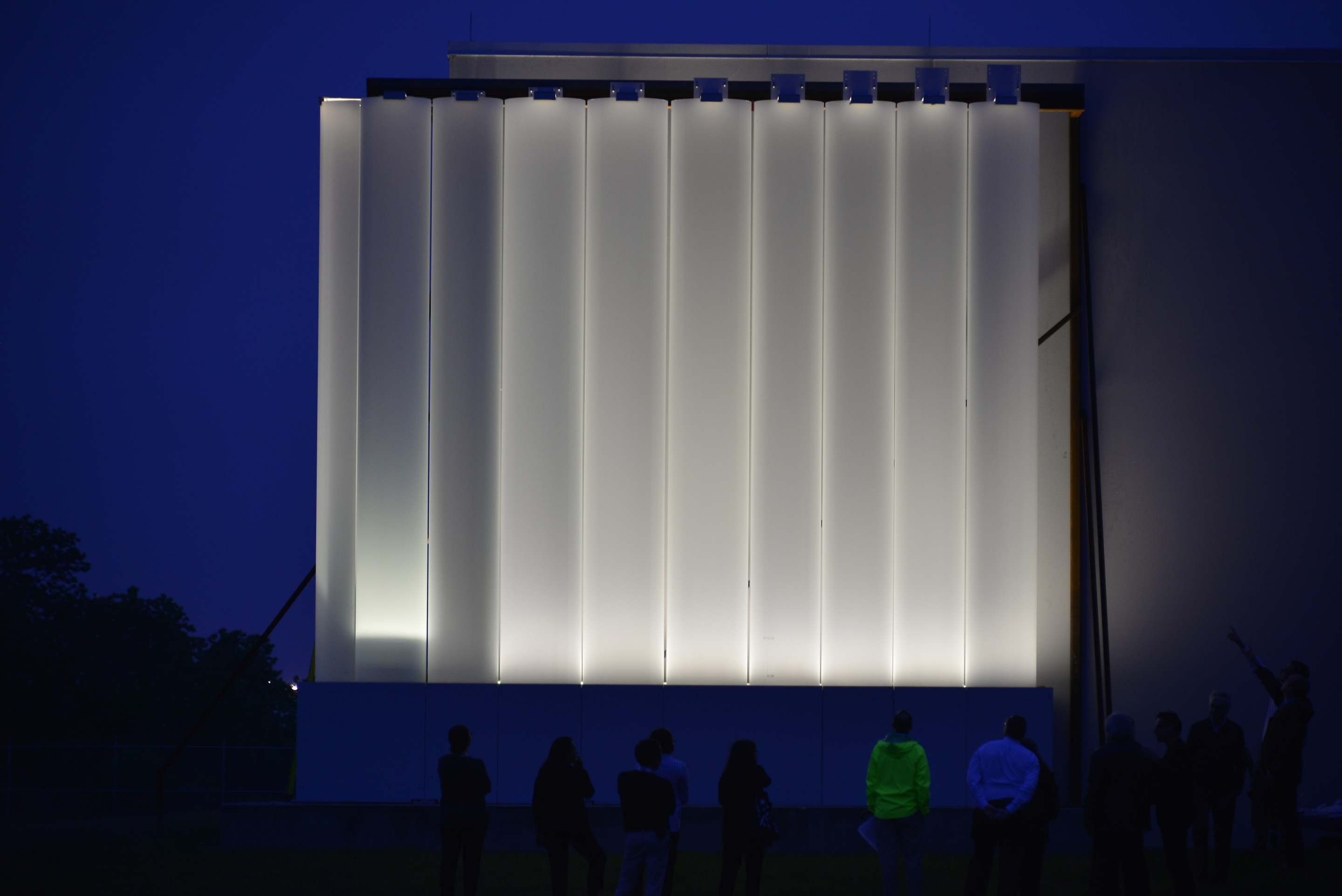 Image of facade mock up at night with lamp-like glow across the kinder building