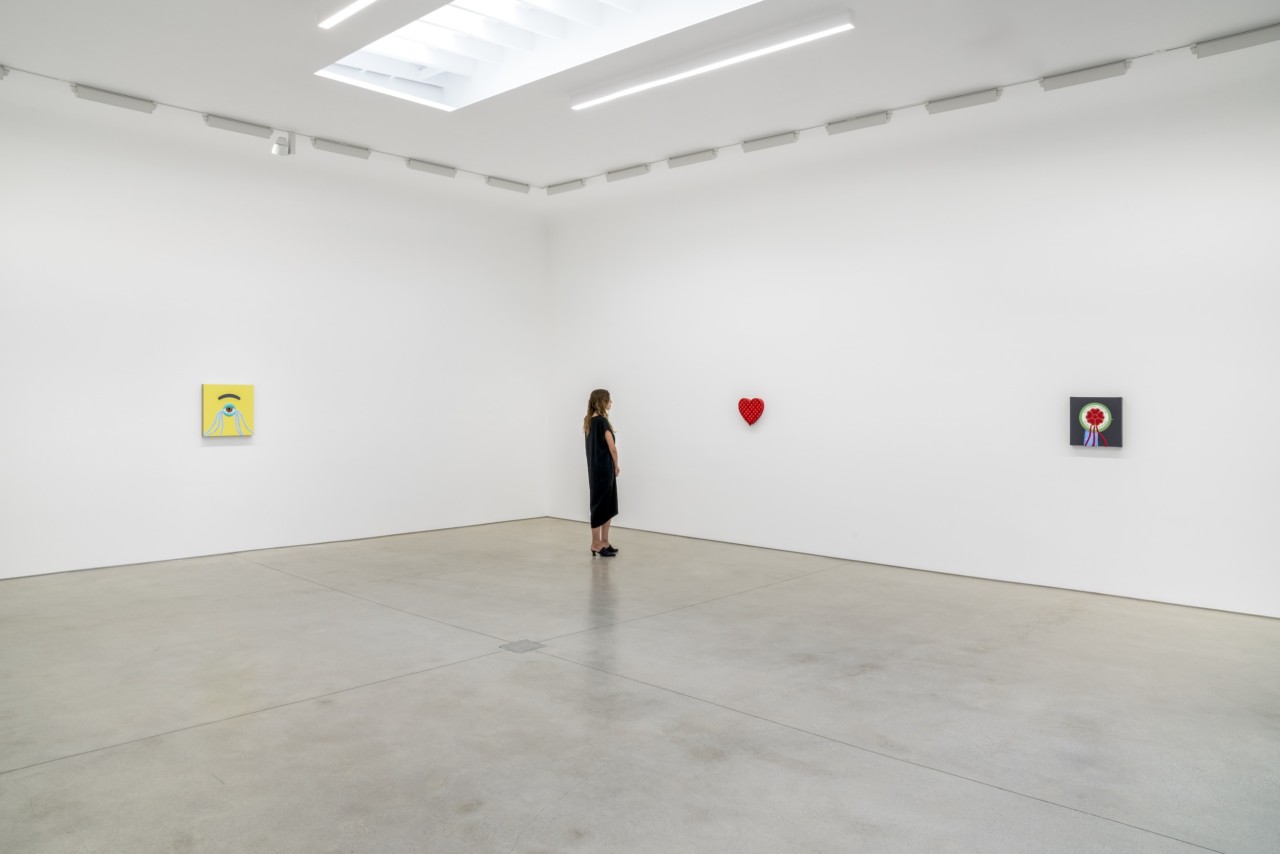 a woman views contemporary art in a gallery space
