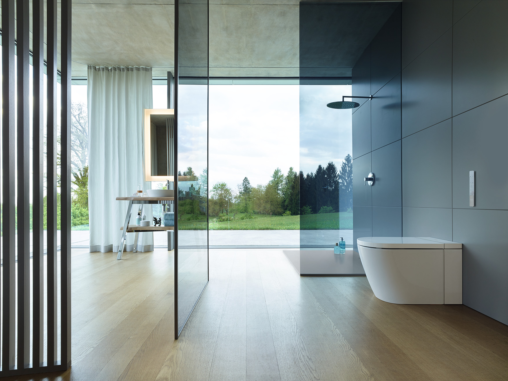 Clear glass partitions in front of a toilet, a 2020 best of products awards winner