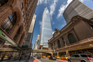 grand central station and a skyscraper in the background with one vanderbilt